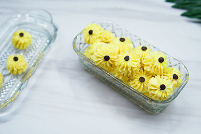 High angle view of yellow flowers on table