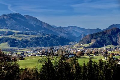 Panoramic view of townscape and mountains against sky