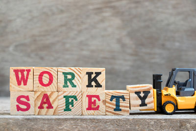 Close-up of text and toy car on table