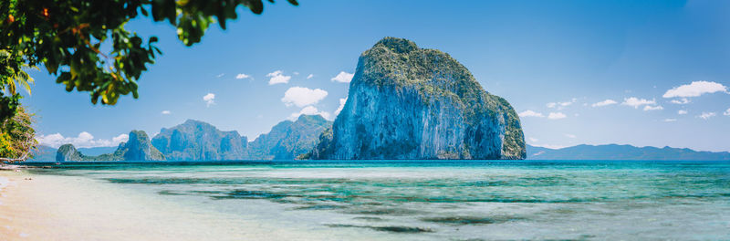 Panoramic view of sea against blue sky