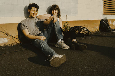 Portrait of young couple sitting outdoors