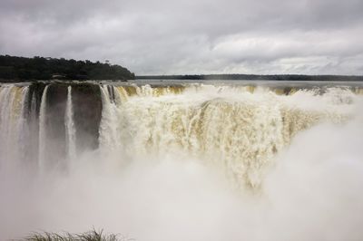 Panoramic view of waterfall against sky