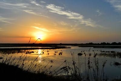 Scenic view of lake against sky during sunset