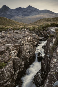 Beautiful view of a little river and a mountain into the isle of skye