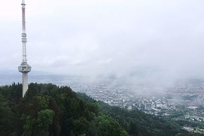 Cityscape against cloudy sky