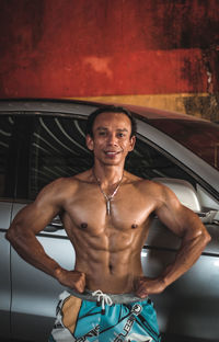 Portrait of shirtless man smiling