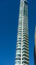 Low angle view of modern building against clear blue sky