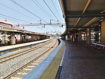 Train at railroad station against sky