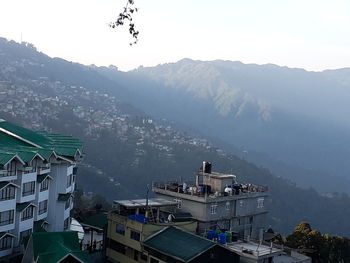 High angle view of buildings and mountains against sky