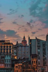 Buildings in city at sunset