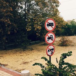 Road sign against trees