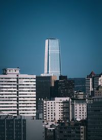 Modern buildings in city against clear sky