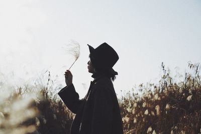 Silhouette person standing on field against sky