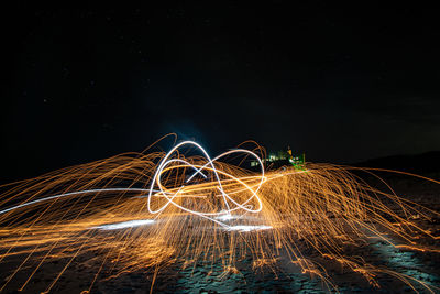 View of illuminated light painting against dark