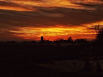 Silhouette landscape against sky during sunset