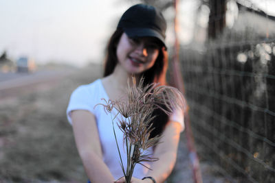 Portrait of smiling young woman standing outdoors