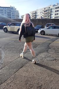 Full length of woman on road in city