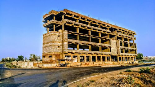 Incomplete building against clear blue sky