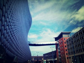 Low angle view of building against cloudy sky