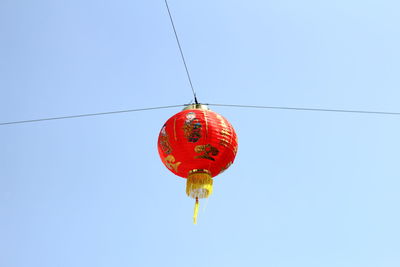 Low angle view of chinese lantern hanging against clear sky