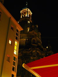 Low angle view of illuminated building against sky at night