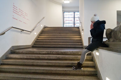 Low angle view of man walking up stairs