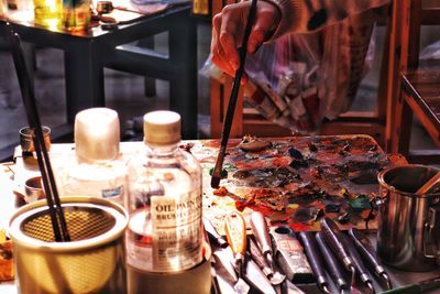 Cropped hand of painter holding brush