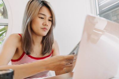 Young woman using laptop at office
