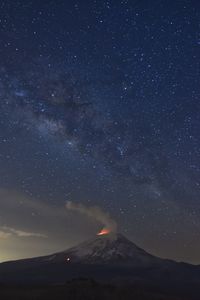 Scenic view of mountain against star field at night