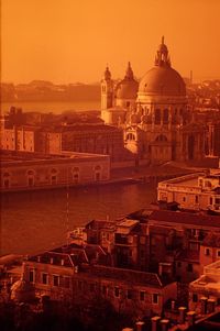 Santa maria della salute by grand canal in city during sunset