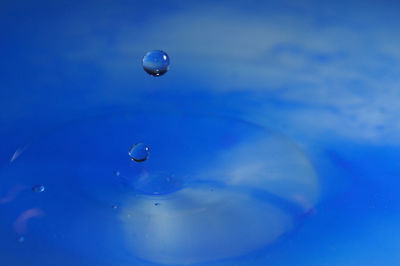 Close-up of drops in mid-air over water