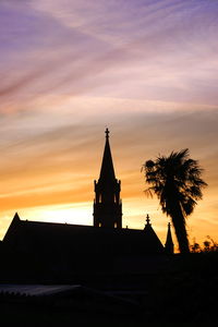 Silhouette of building against sky during sunset