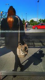 Rear view of people on road against sky