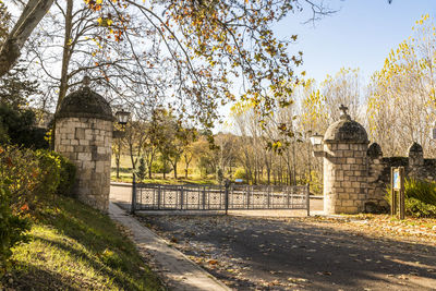Trees in front of building against clear sky