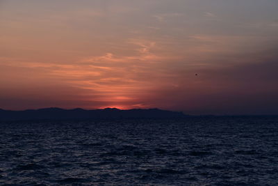 Scenic view of sea against orange sky