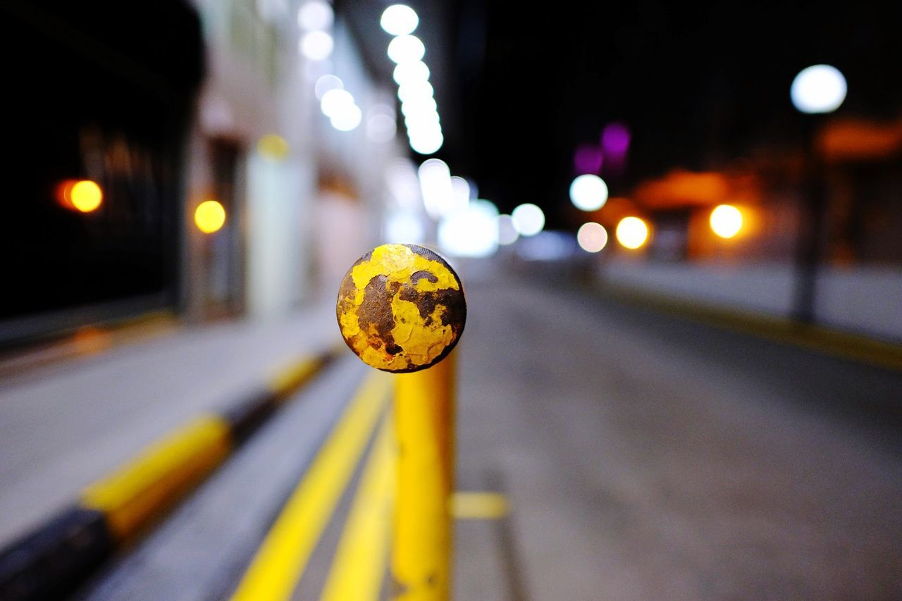 CLOSE-UP OF YELLOW CAR ON STREET