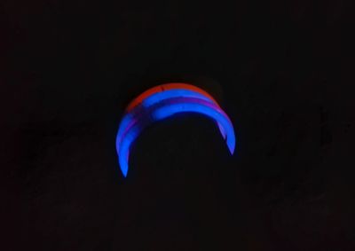 Close-up of illuminated light over black background