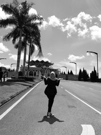 Full length of man walking on road against sky