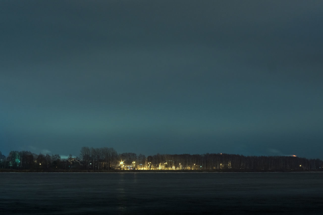 SCENIC VIEW OF LAKE AGAINST SKY AT NIGHT IN CITY