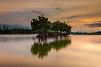 Scenic view of lake against sky at sunset