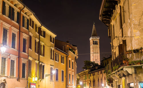 Low angle view of illuminated buildings against sky at night