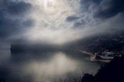 Scenic view of sea by city against sky