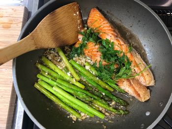 High angle view of fish and vegetables in a pan.