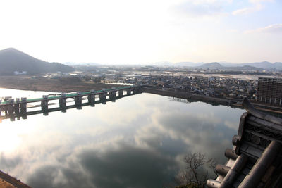 High angle view of river amidst buildings against sky