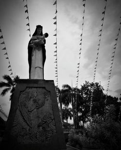 Low angle view of statue against sky