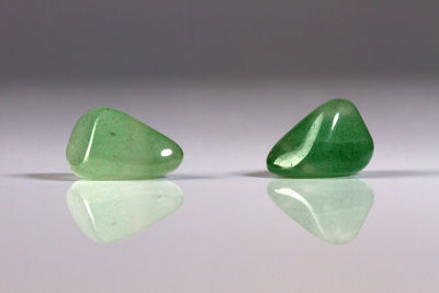 Close-up of green stones over white background