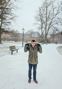 Full length of boy standing on snow field