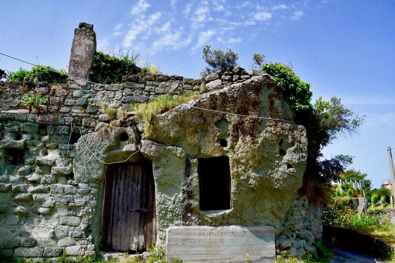 architecture, built structure, building exterior, old, low angle view, sky, abandoned, house, weathered, damaged, stone wall, obsolete, deterioration, tree, run-down, blue, day, plant, old ruin, no people