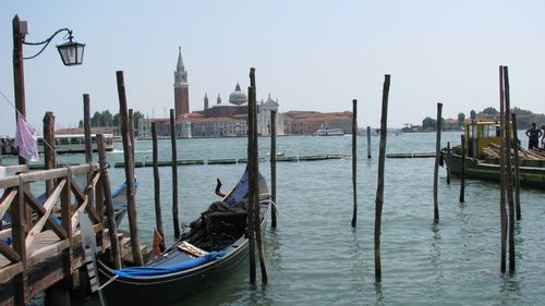 Gondolas moored at grand canal against sky