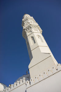 Low angle view of mosque against clear blue sky